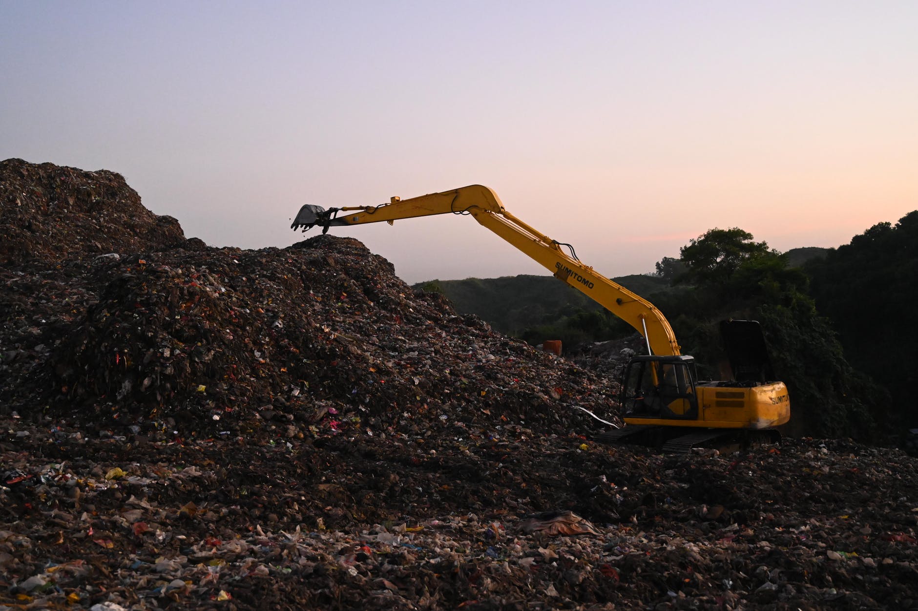 photo of backhoe on landfill