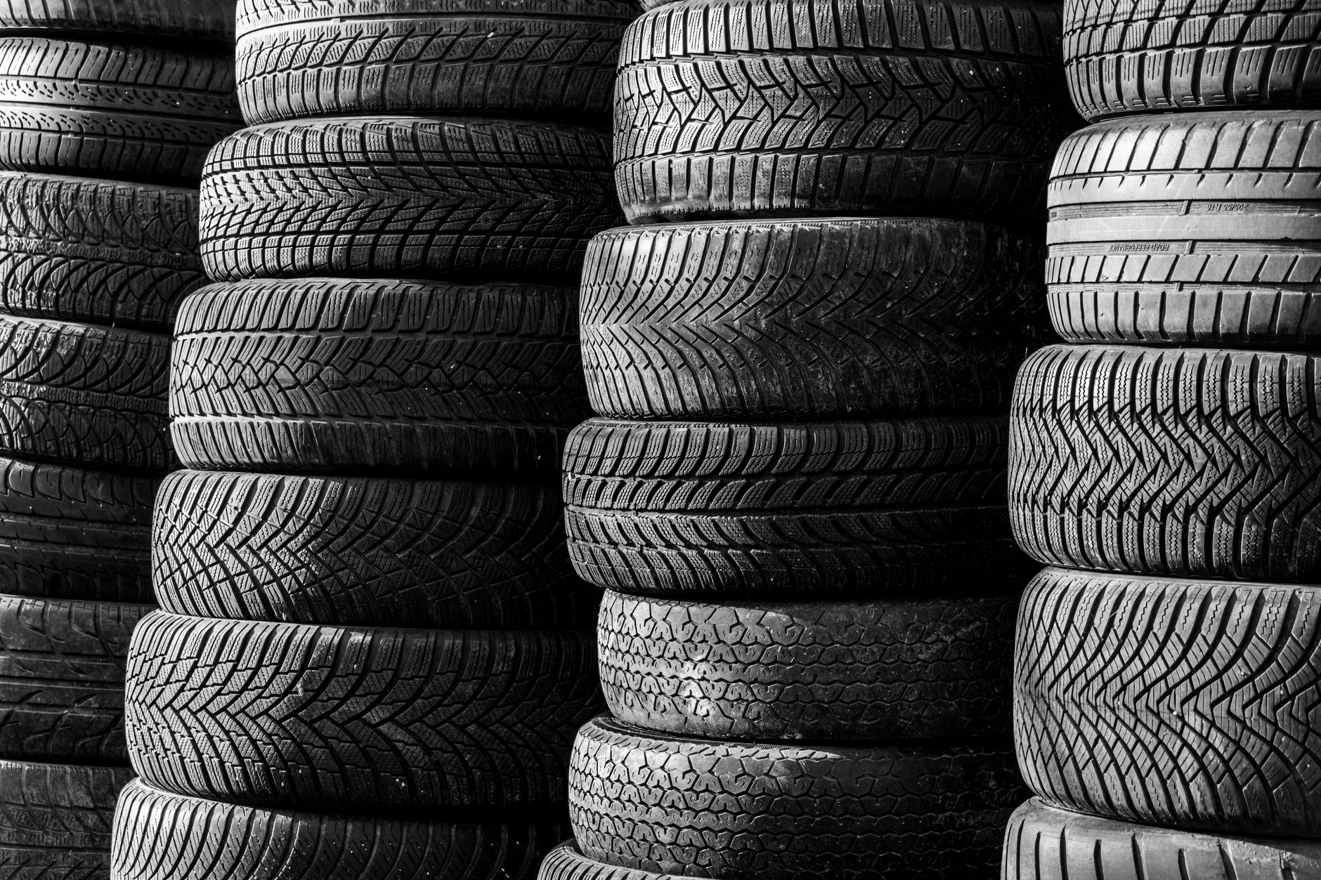 stacked vehicle tires in black and white